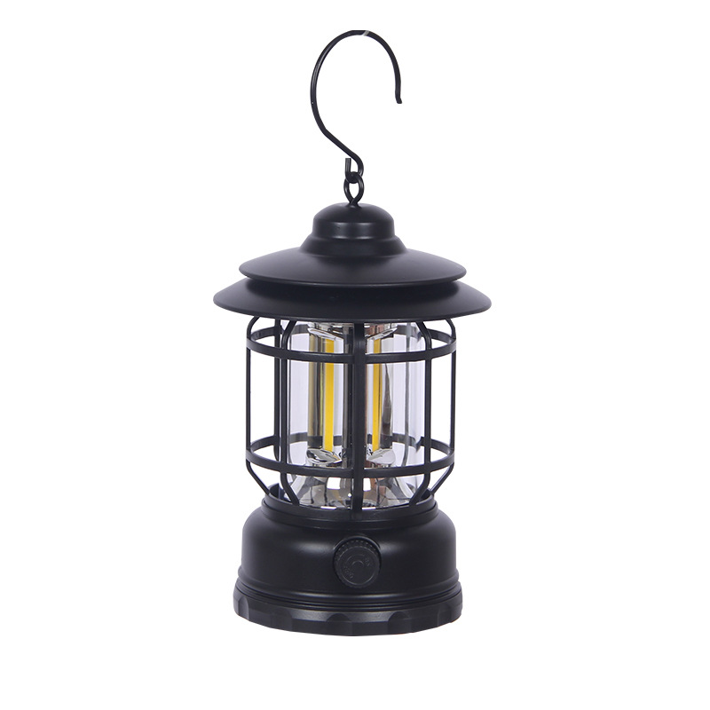 Camping lantern lighting a table at a campsite